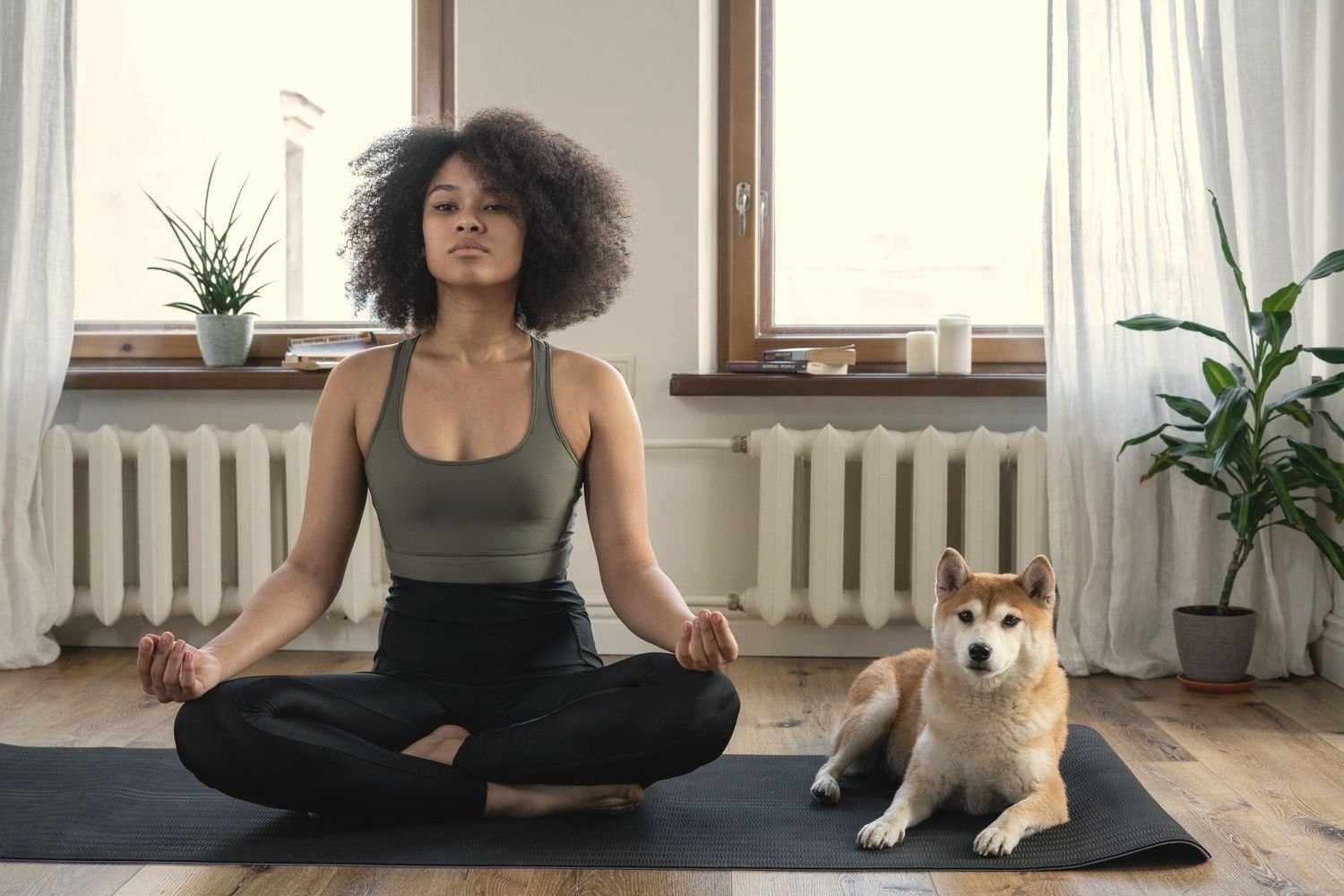 A woman relaxing at home with her dog beside her