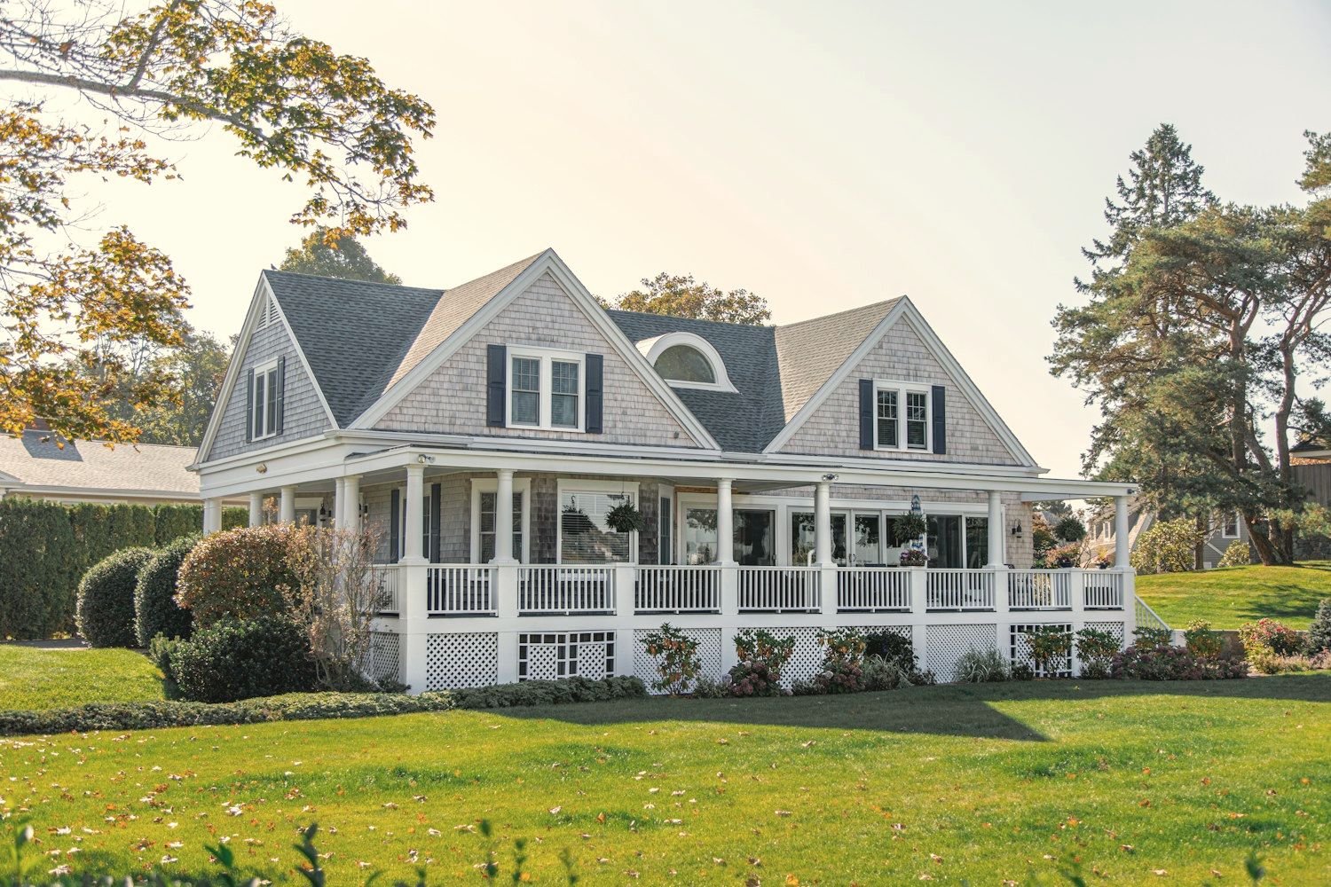 A classic American home with a covered front porch and green lawn